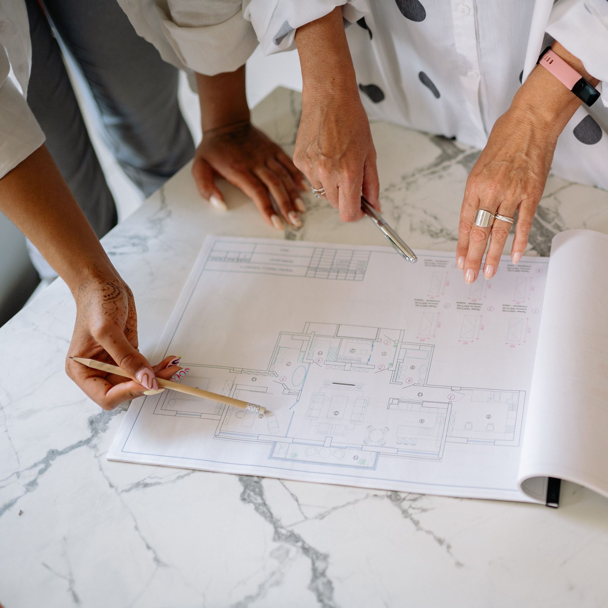Two professionals reviewing architectural drawings